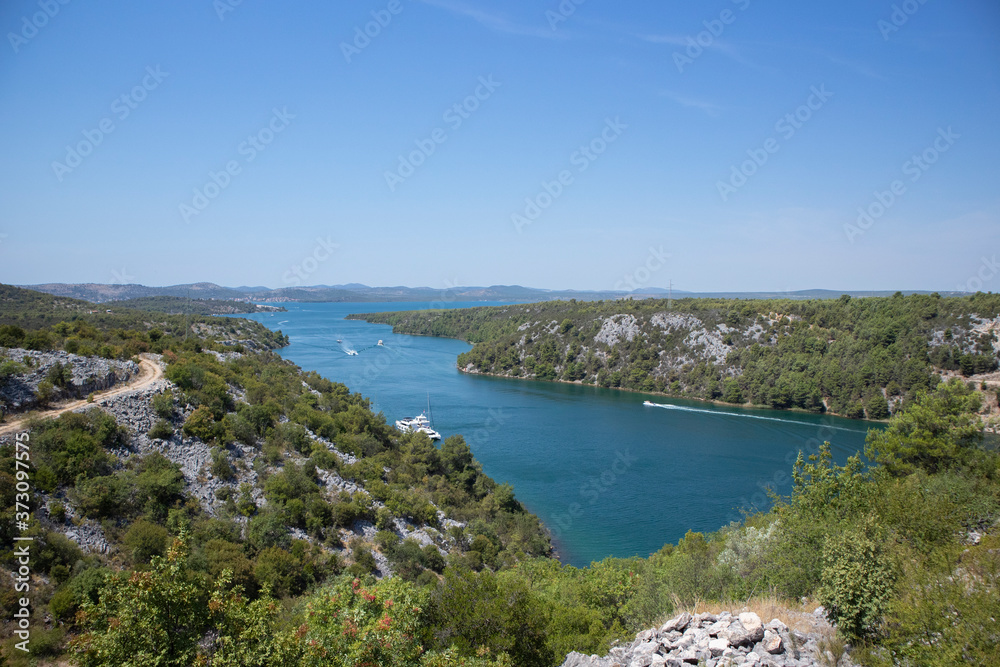 Beautiful Skradin bay and Krka river going into Adriatic sea, surrounded by steep cliffs and green vegetation