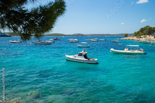 Beautiful dalmatian sea off the coast of Hvar island, full of small, white boats anchored in the Majerovica bay