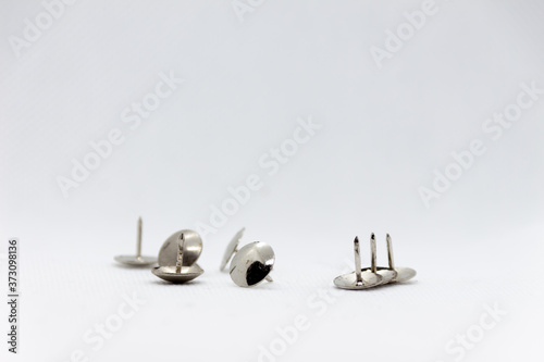 some thumbtacks in a white background