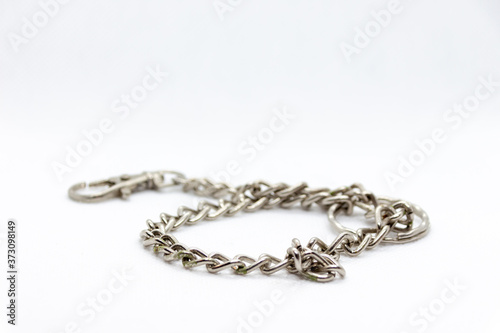 metal chain coiled on white background