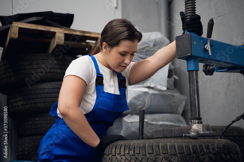 Female mechanic enjoys working on a machine tool