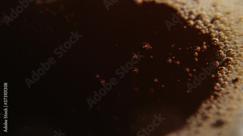 Macro photography of coffee, dropping a drop of coffee into a liquid.