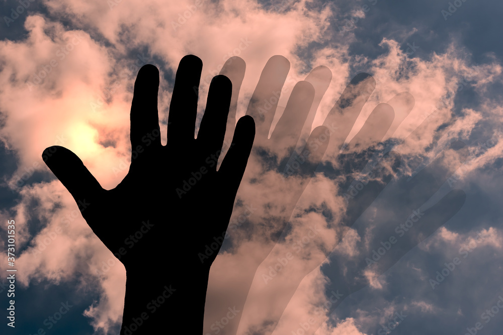 blurred motion hand silhouette against cloudy sky,concept image about blurry sight,day dream