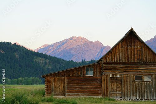 Sunrise over Mormon Row in Grand Teton National Park with the mountains in the background in Wyoming, United States photo