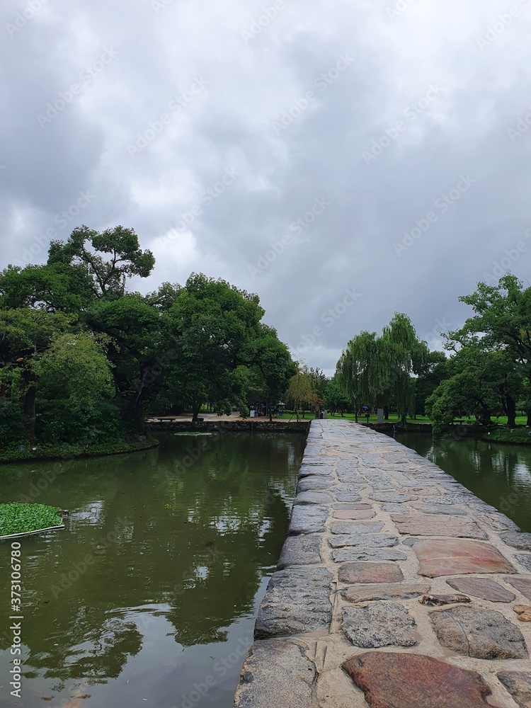 Fototapeta premium Namwon-si, Jeollabuk-do, South Korea - 24th July 2020 : Bridge and Scenery of Gwanghallu Garden or Gwanghallu Pavilion on a rainy day