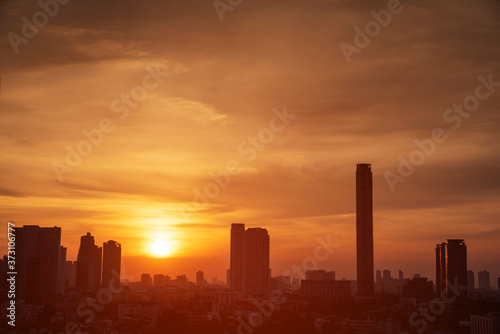Beautiful cityscape in sunset aerial view of Bangkok with building silhouette. © wirat
