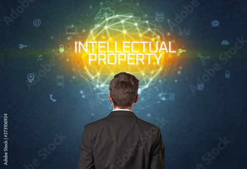 Rear view of a businessman with INTELLECTUAL PROPERTY inscription, online security concept