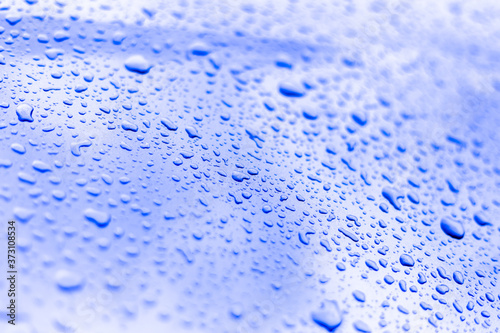 Close up water drops on sky blue tone background.Abstarct blue wet texture