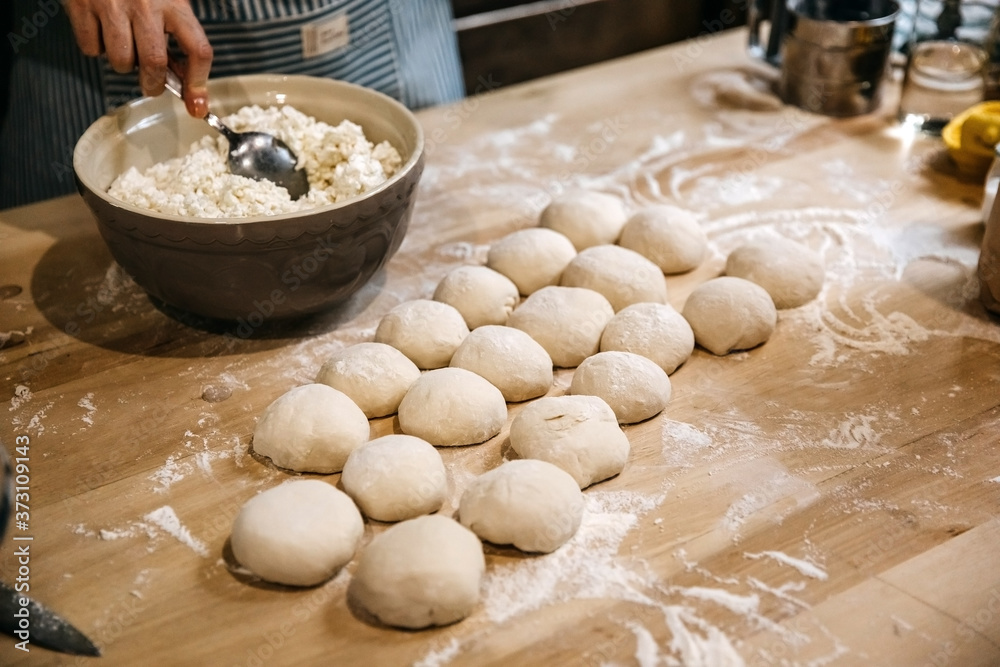 Fototapeta premium Making of traditional pies with cottage cheese.