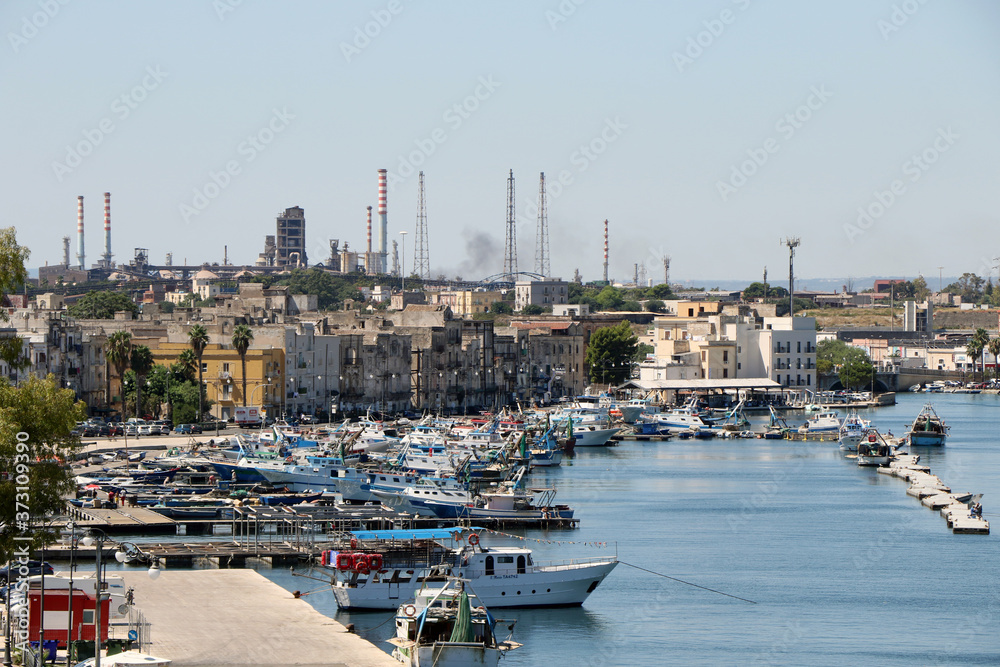Overview of the marina in the old city of Taranto with dozens of moored fishing boats. Taranto, Puglia, Italy