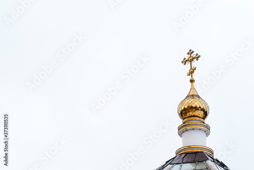 The dome of the Orthodox cathedral with a cross, a white background.