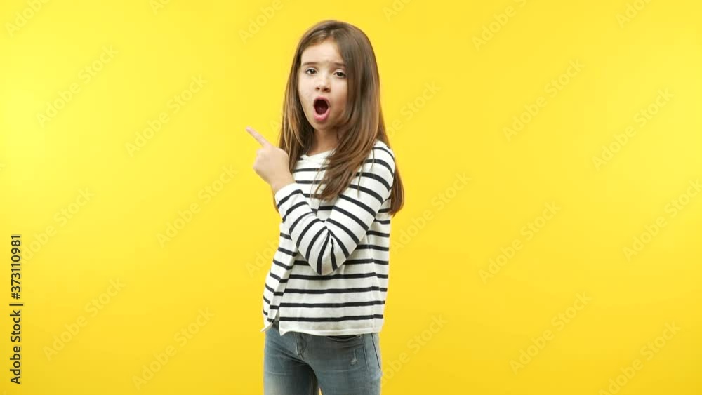 Funny little child girl pointing to the side Funny little child girl pointing to the side