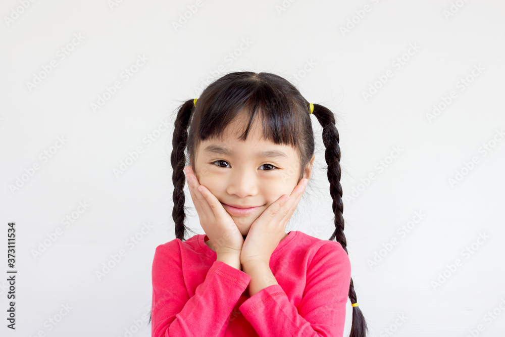 asian child hold her cheeks and smile happily on white background asian child hold her cheeks and smile happily on white background