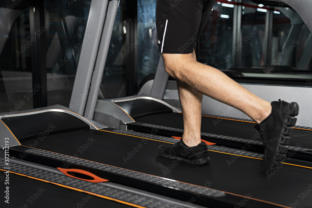 Close up of male legs running on treadmill in gym, Sport fitness training, Lifestyle people concept