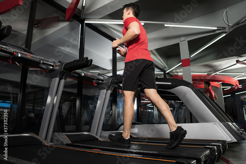 Athletic young man running in gym, Sport fitness training