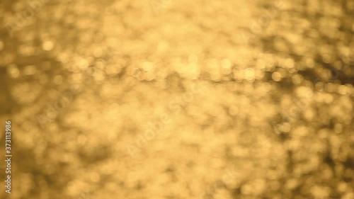 beautiful bokeh of dancing sun reflection on water from the ocean wave at sunset time, abstract background, high definition, Full HD, 1920x1080