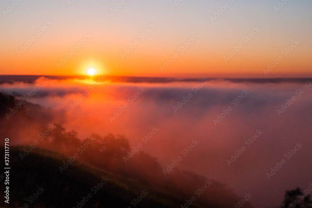 Sunrise over the cliff.
morning haze at dawn on a cliff in summer.