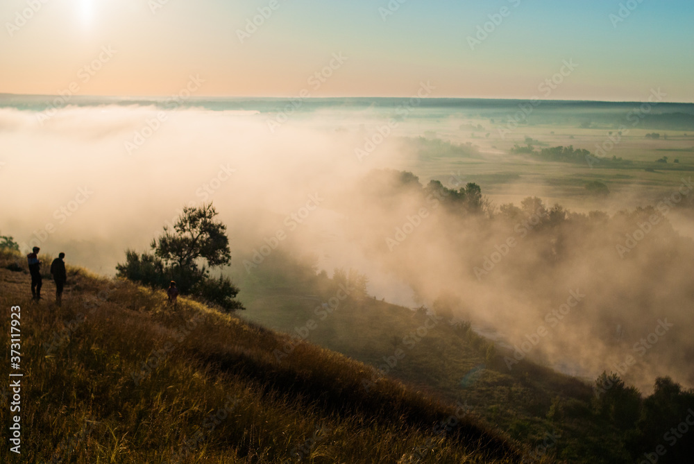 Fototapeta premium Sunrise over the cliff. Morning haze at dawn on a cliff in summer. freshness