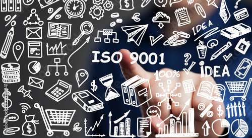 The concept of business, technology, the Internet and the network. A young entrepreneur working on a virtual screen of the future and sees the inscription: ISO 9001