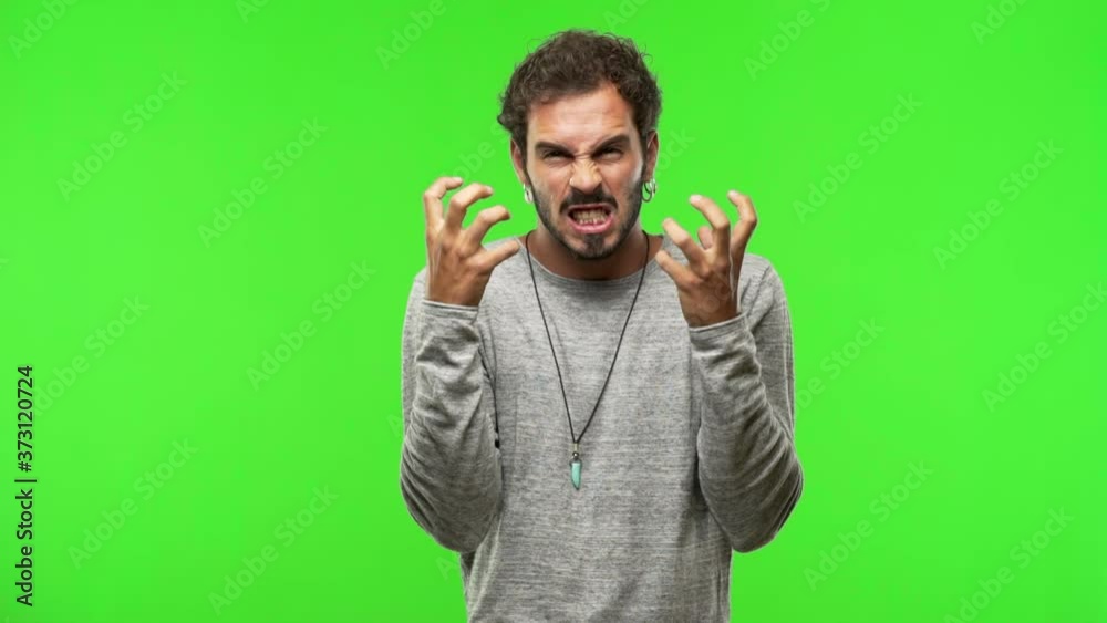 young man on chroma green screen angry and upset