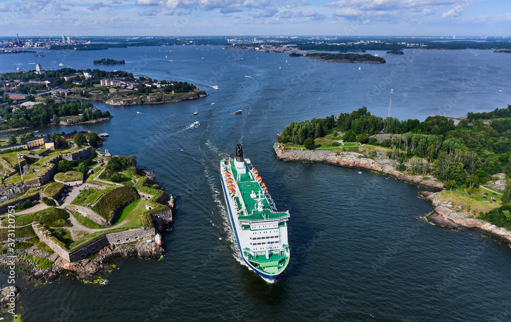 The cruise ferry is departing from Helsinki and moving near the Suomenlinna island, Finland.