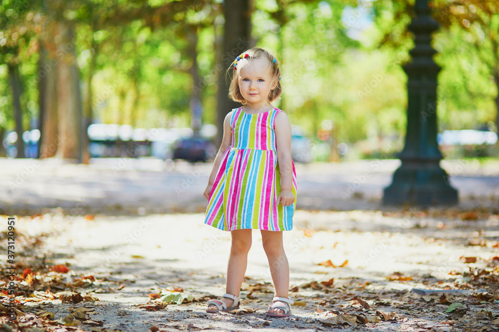 Adorable toddler girl having fun outdoors on a sunny summer day Adorable toddler girl having fun outdoors on a sunny summer day