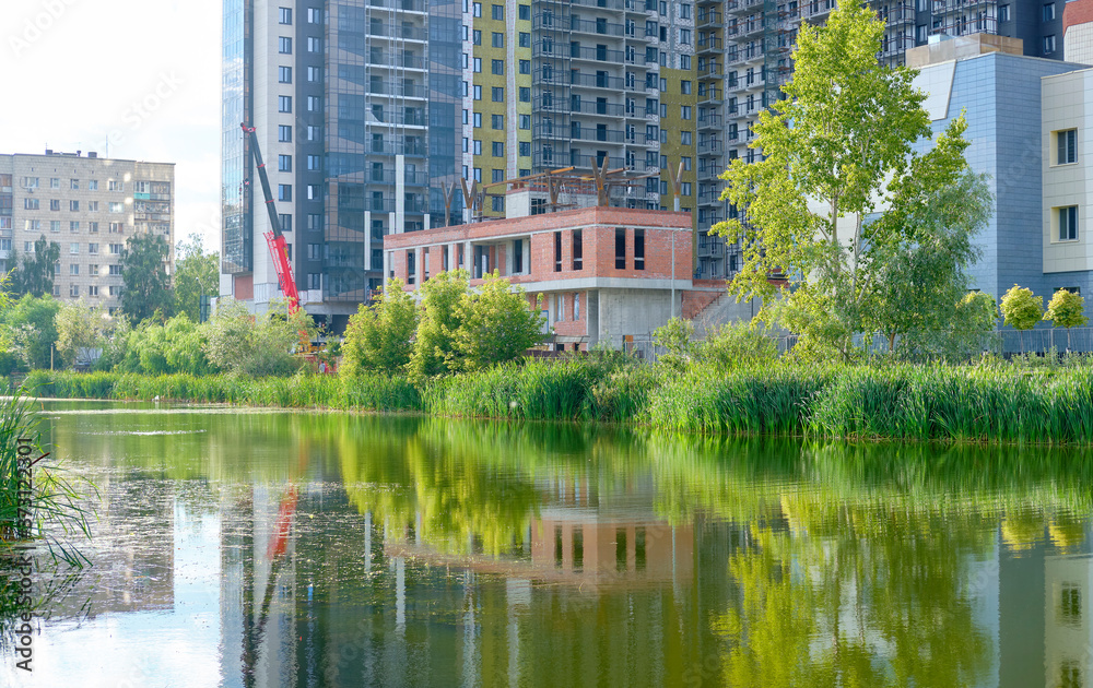 modern building in the park. lake in front of the house. City Park