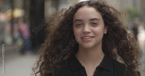 Young woman in city face portrait smile happy