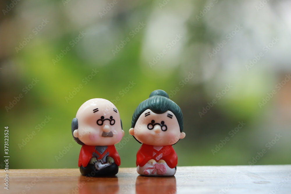 Fototapeta premium Miniature Japanese style ceramic doll garden ornaments Is a pair of happy old people