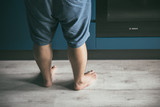 Male and female feet in the home kitchen while cooking. Romantic cooking in a city apartment. The lifestyle of modern youth. Image with selestive focus. 