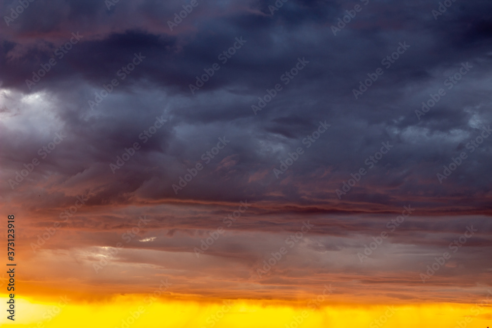 Very beautiful sunset in the city or village. Pink-orange sky with clouds.