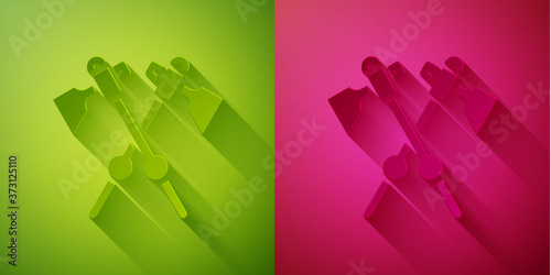 Paper cut Crossed medieval axes icon isolated on green and pink background. Battle axe, executioner axe. Medieval weapon. Paper art style. Vector.