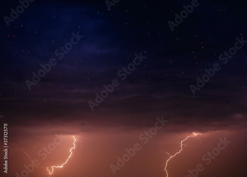 Lightning and storm clouds in the night sky over the sea