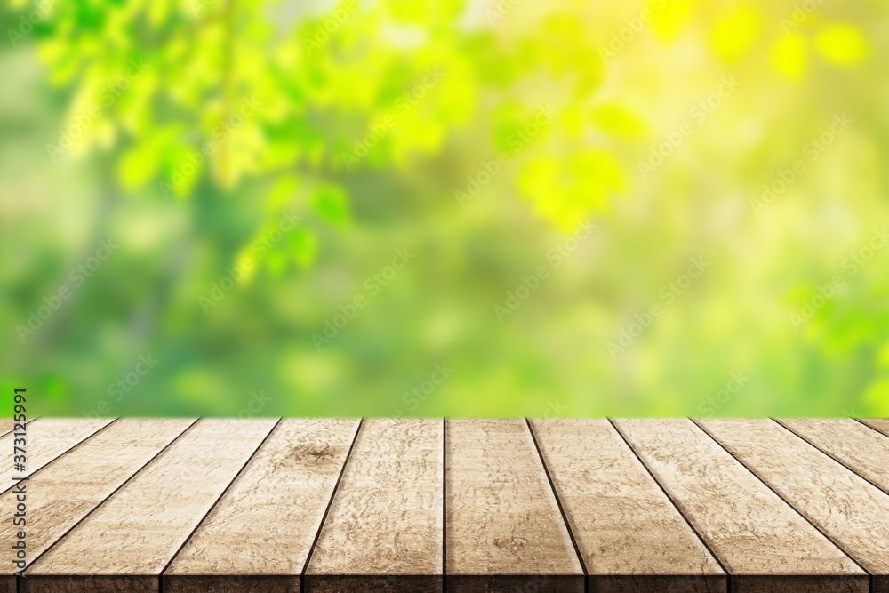 Wood floor with blurred trees of nature park background and summer season, product display montage Wood floor with blurred trees of nature park background and summer season, product display montage