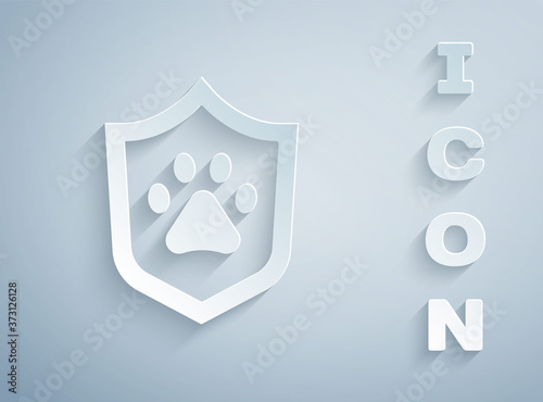 Paper cut Animal health insurance icon isolated on grey background. Pet protection concept. Dog or cat paw print. Paper art style. Vector.
