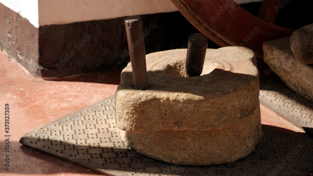 Αυτοκόλλητο Closeup shot of a hand millstone on the ground