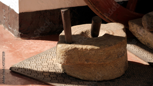 Fényképezés Closeup shot of a hand millstone on the ground