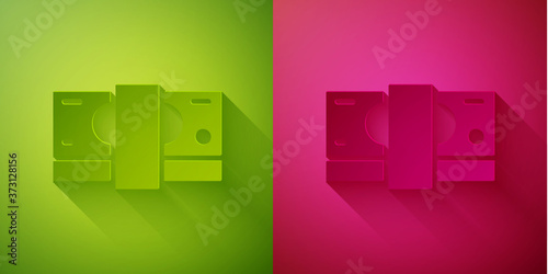 Paper cut Stacks paper money cash icon isolated on green and pink background. Money banknotes stacks. Bill currency. Paper art style. Vector.