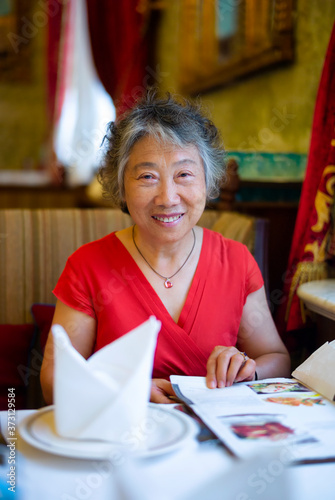 Portrait of happy senior beautiful woman in restaurant