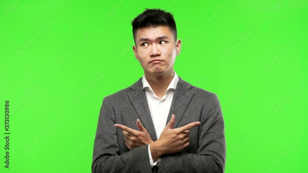 Young chinese business man decide between two options Young chinese business man decide between two options