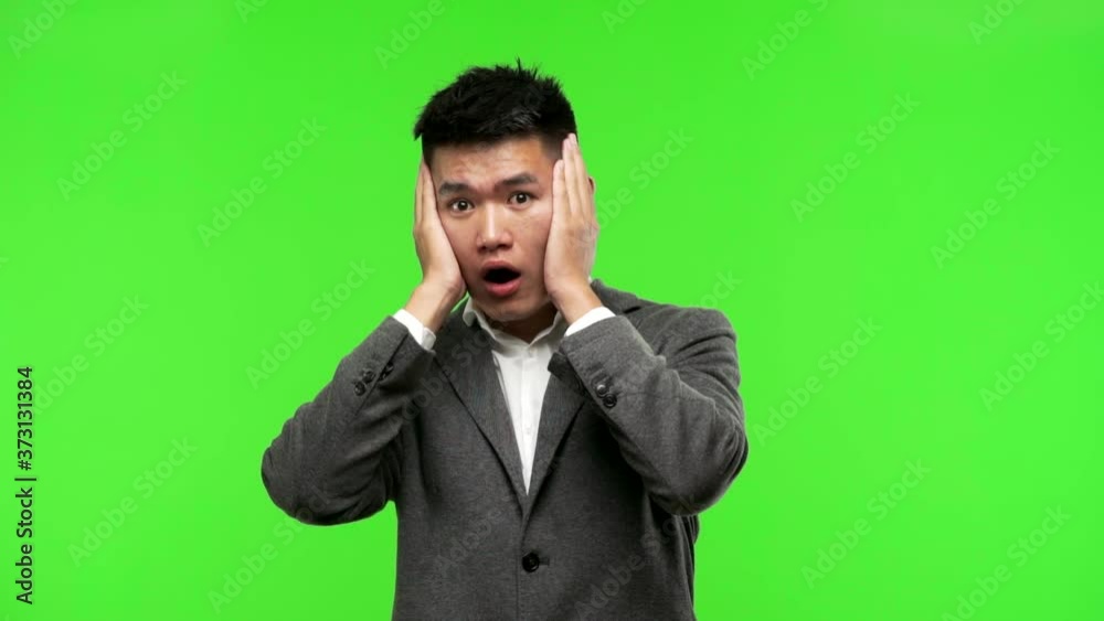 Young chinese business man surprised and shocked Young chinese business man surprised and shocked