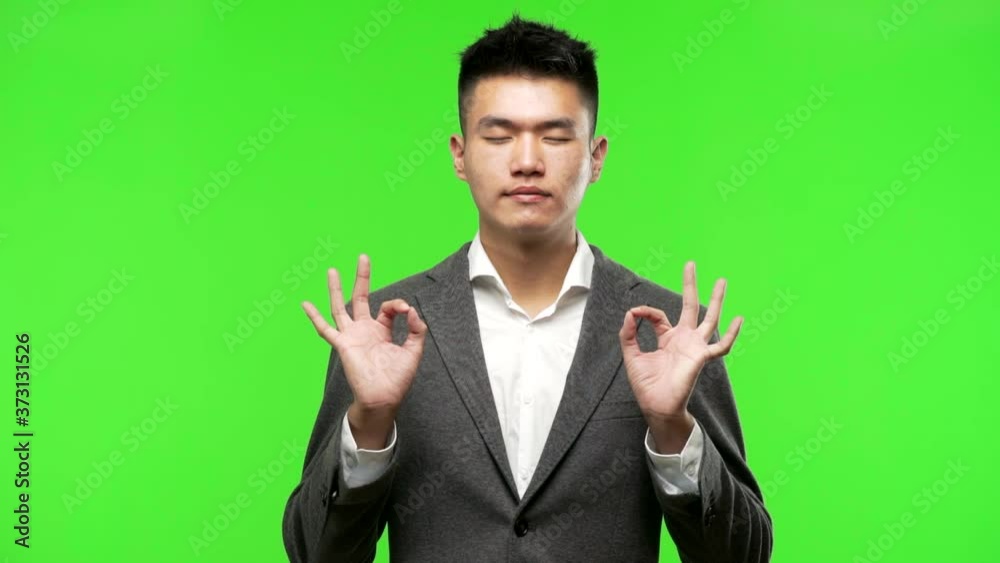 Young chinese business man performing yoga Young chinese business man performing yoga