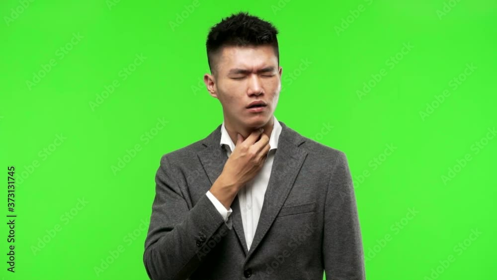 Young chinese business man coughing Young chinese business man coughing