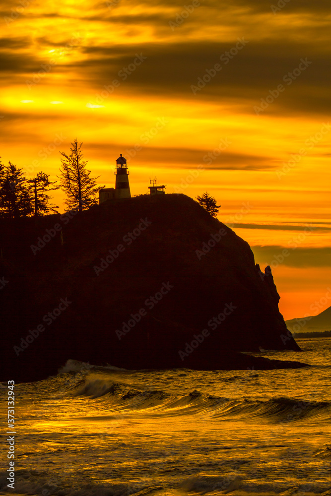 The Cape Disappointment Lighthouse at sunset at the mouth of the Columbia River on the washington coast near Ilwaco.