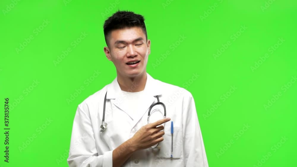 Young chinese doctor man pointing to the side Young chinese doctor man pointing to the side
