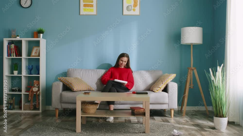 Young woman is trying to relieve stress by using drawing therapy, tears out sheets of paper, making efforts to get rid of negative feelings and emotions, Slow motion. Young woman is trying to relieve stress by using drawing therapy, tears out sheets of paper, making efforts to get rid of negative feelings and emotions, Slow motion.