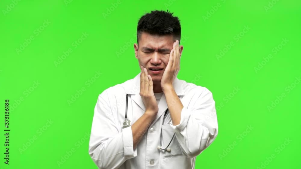 Young chinese doctor man desperate and sad Young chinese doctor man desperate and sad
