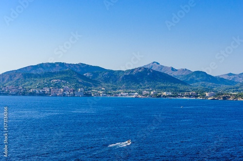 Santa Ponsa, Mallorca, Spain. View on the sea with mountains, boat, sailboat, blue sky.