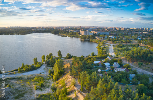 Lake near the forest and the city in the background
