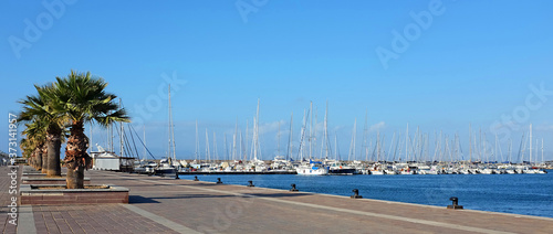 Mediterranean seafront, with boat and yacht marina in the distance